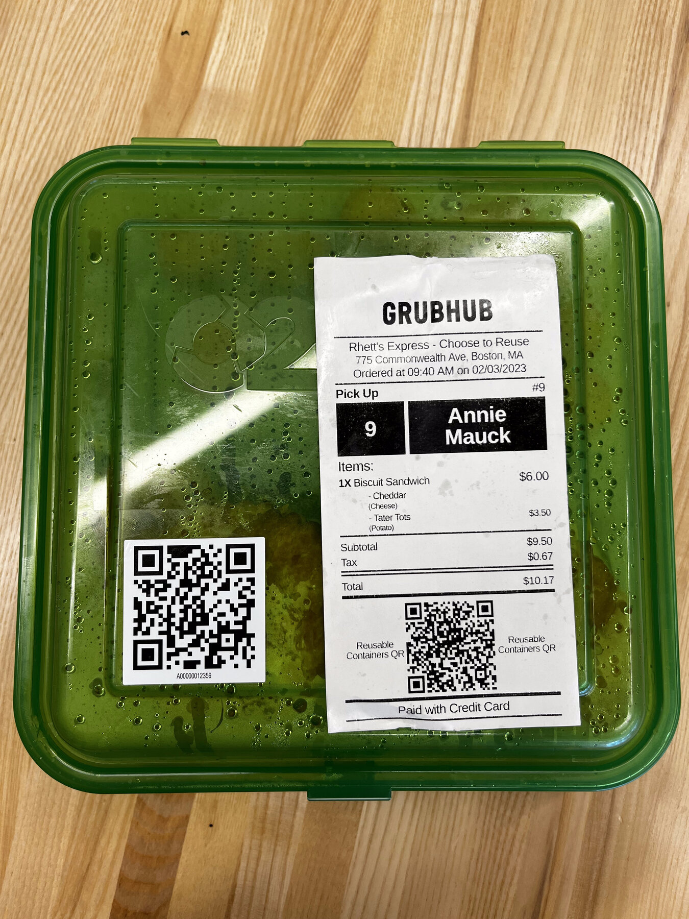 A ReusePass container with a Grubhub order receipt taped to the lid, showing matching Reusable Containers QR codes on both the receipt and the container label